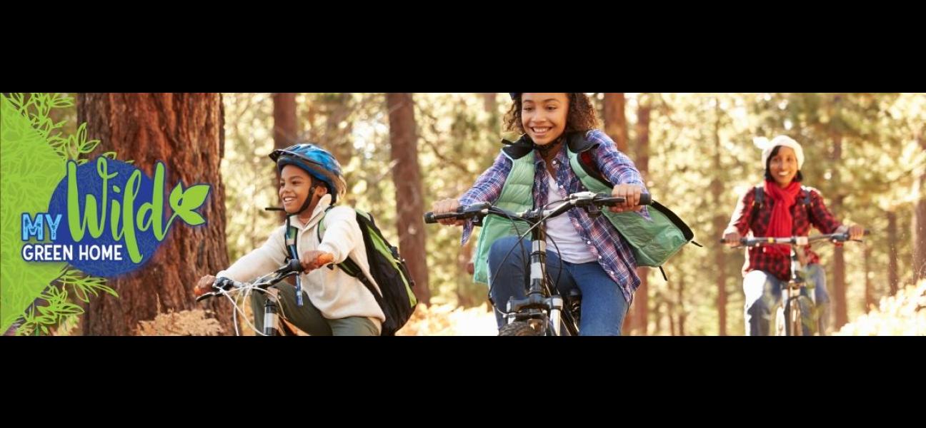 Two kids are riding bikes on a trail with a parent following closely behind.