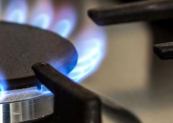 Close up of a gas stove burner turned on. 